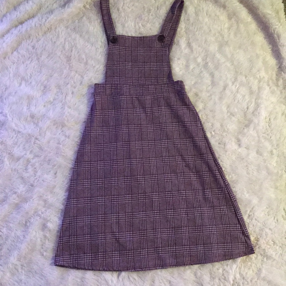 A suspender dress/skirt, knee length button strap